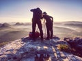 Two hikers taking pictures and talk on top of mountain. Two photographers Royalty Free Stock Photo