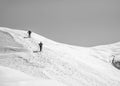 Two Hikers on a trail walking through snow. Winter landscape in Carapathian Mountains, Romania Royalty Free Stock Photo