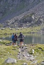 Two hikers walk around the lakes