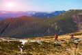 Two Hikers walking along Mountain ridge with Sun shining Royalty Free Stock Photo