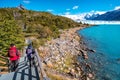 Two hikers and walking path at Lago Argentino near huge Perito Moreno glacier in Patagonia in golden Autumn, South America Royalty Free Stock Photo