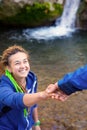 Two Hikers young Man and Smiling Woman holding hands vertical Royalty Free Stock Photo