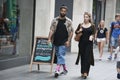 Two hipster girls dressed in cool Londoner style walking in Brick lane, a street popular among young trendy people Royalty Free Stock Photo