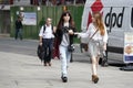 Two hipster girls dressed in cool Londoner style walking in Brick lane, a street popular among young trendy people Royalty Free Stock Photo