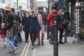 Two hipster girls dressed in cool Londoner style walking in Brick lane, a street popular among young trendy people Royalty Free Stock Photo