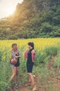 Two hipster woman traveling and enjoying with flower field together, relaxing good time sunny day. Royalty Free Stock Photo