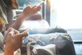 Two of hipsters woman sitting on sofa holding en hands and using mobile phone. Royalty Free Stock Photo