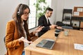 Two hispanic call center agents working at the office Royalty Free Stock Photo