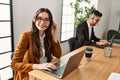 Two hispanic call center agents working at the office Royalty Free Stock Photo