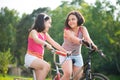 Two hispanic children riding on bikes