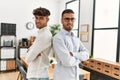 Two hispanic men business workers standing with arms crossed gesture at office Royalty Free Stock Photo
