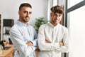 Two hispanic men business workers standing with arms crossed gesture at office Royalty Free Stock Photo