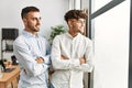 Two hispanic men business workers standing with arms crossed gesture at office Royalty Free Stock Photo