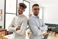 Two hispanic men business workers standing with arms crossed gesture at office Royalty Free Stock Photo