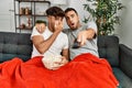 Two hispanic men couple watching movie sitting on sofa at home Royalty Free Stock Photo