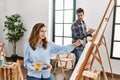 Two hispanic students painting at art school Royalty Free Stock Photo