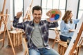 Two hispanic students painting at art school Royalty Free Stock Photo