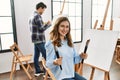 Two hispanic students painting at art school Royalty Free Stock Photo