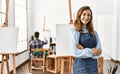 Two hispanic students painting at art school Royalty Free Stock Photo