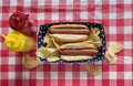 Two hog dogs with chips on Fourth of July setting with mustard and ketchup