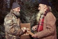 Two holemess men exchanging gifts of food in christmas time Royalty Free Stock Photo