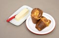 Two Home Baked Popovers and a Stick of Butter Royalty Free Stock Photo