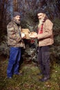 Couple of homeless men in winter park celebrating christmas alone