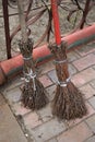 Two homemade broom branches in the yard