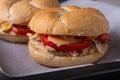 Two homemade burger Vienna Kaiser bread bun bread roll with chicken meat tomato mustard mayonnaise on baking tray sheet parchment Royalty Free Stock Photo