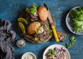 Two homemade burgers on a wooden cutting board, top view. Royalty Free Stock Photo