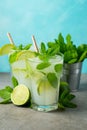 Two homemade lemonade or mojito cocktail with lime, mint and ice cubes in a glass on a light stone table. Fresh summer drink Royalty Free Stock Photo