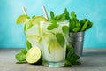 Two homemade lemonade or mojito cocktail with lime, mint and ice cubes in a glass on a light stone table. Fresh summer Royalty Free Stock Photo