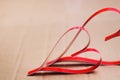 Two homemade paper red hearts on a cardboard background close up, the symbol of Valentine`s Day and love Royalty Free Stock Photo