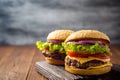 Two homemade tasty burgers on wooden table