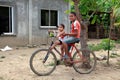 Two Honduran Children sitting on Bicycle in Rural Village