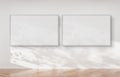 Two horizontal frames hanging on a wall mockup 3d rendering