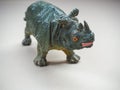 Two-horned rhinoceros toy on golden surface Royalty Free Stock Photo