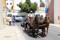 Two-horse excursion carriage in the street of the historic heart of Sintra, Portugal - July 13, 2021