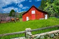 Two horses and a old red barn landscape. Royalty Free Stock Photo