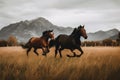 Two horses running in a field with mountains in the background. Generative AI image. Royalty Free Stock Photo