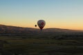 Two hot air balloons against colorful vibrant sky. Picturesque nature landscape in the background Royalty Free Stock Photo