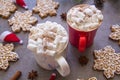 Two hot chocolate cups and marshmallows , against grey background & Christmas composition with Snowflake gingerbread cookies Royalty Free Stock Photo