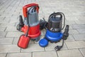 Two household submersible pump with plastic housings on stone floor