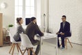 Two HR managers talking to young African-American candidate during job interview Royalty Free Stock Photo