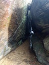 Two huge boulders with a quiet stream of water running under them