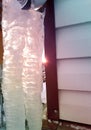 Two huge icicles hanging from a roof at home