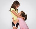 Two hugging sisters looking at each other Royalty Free Stock Photo