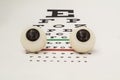 Two human eyeballs lie on the table for testing visual acuity front view. Illustration  for ophthalmology or work ophthalmologist Royalty Free Stock Photo