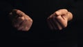 Two human fists isolated on black background Royalty Free Stock Photo