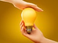 Two human hands holding yellow incadescent light bulb. Concept of energy saving, ecology, innovation,environment care